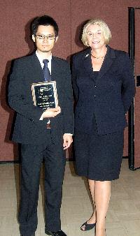 Santi Phithakkitnukoon with UNT President, Dr. Gretchen Bataille, after receiving his award.